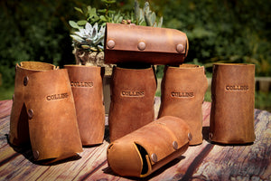 Brown leather beer holder with brass snaps